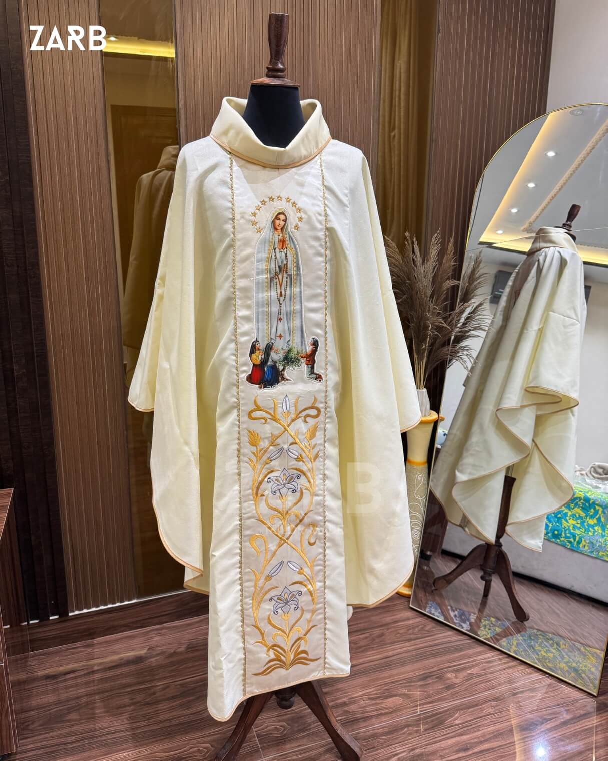 Ivory religious robe with embroidery on a mannequin against a neutral background