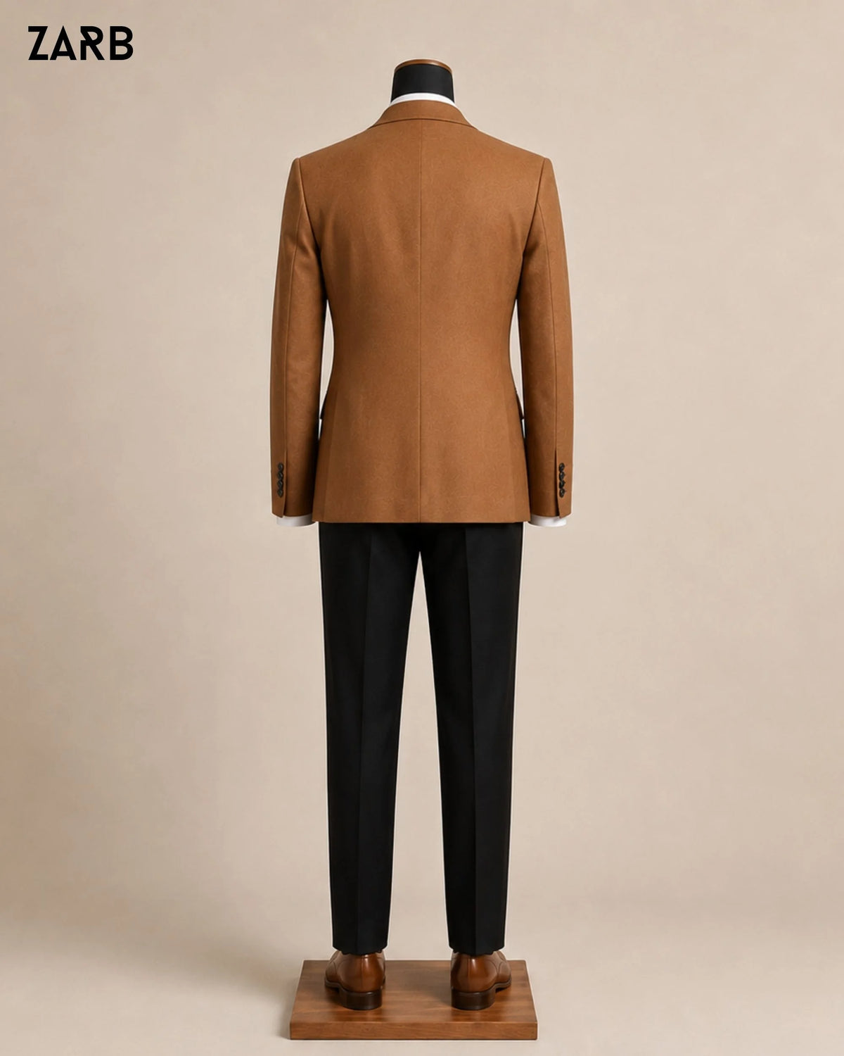Back view of custom tailored rust brown wedding jacket with black formal trousers on male mannequin