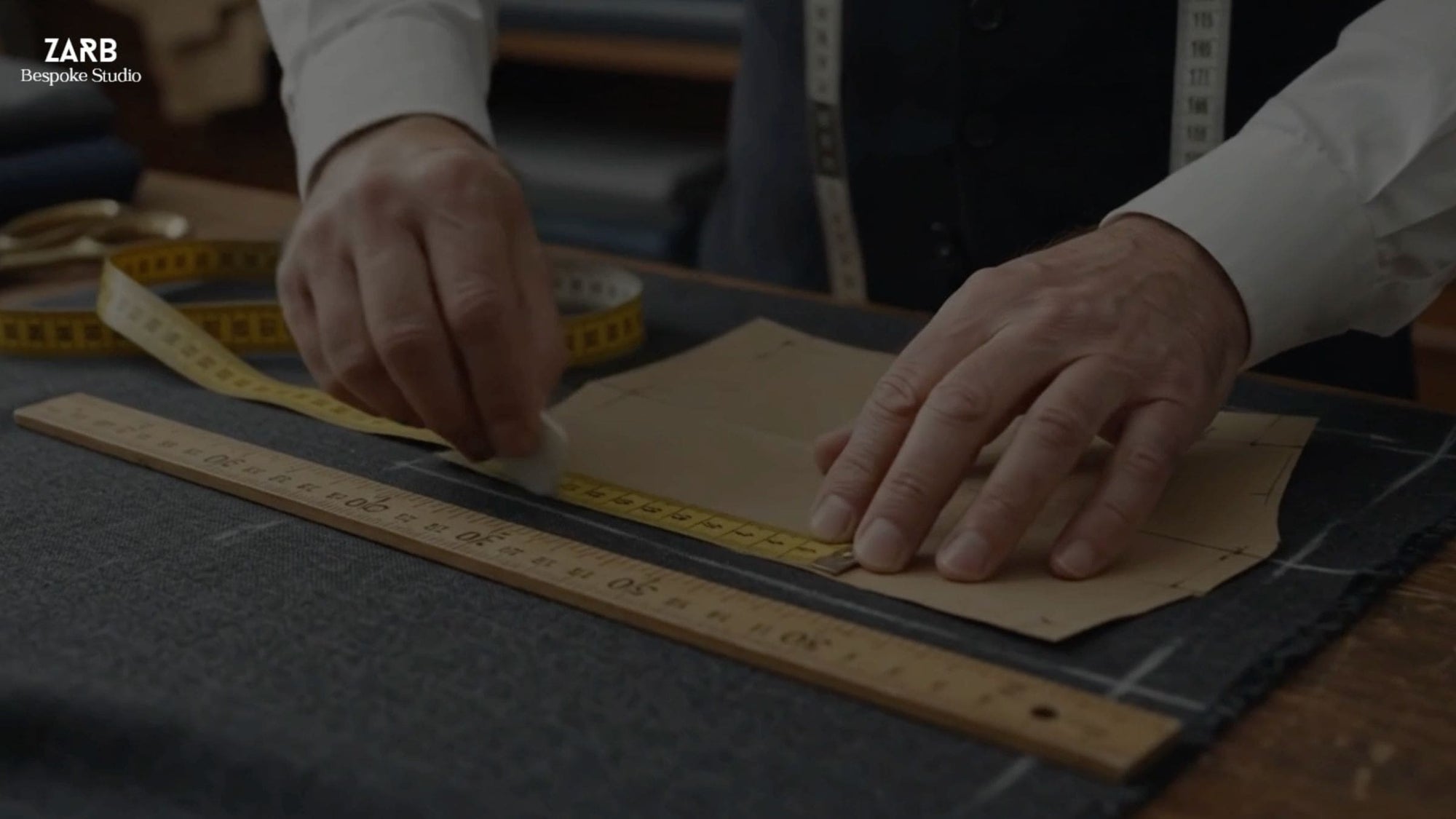 Tailor cutting a suit fabric